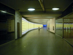 Tunnel between the northern entrances and the platforms. The lights on the left wall change colour