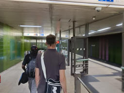 From the northern concourse, the northeast-bound platform on the right, escalators down to the southwest-bound platform on the left