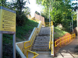 The two options to get to the platform for trams to Manchester from Middleton Road: stairs on the left, ramp on the right
