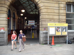 The side entrance to Manchester Victoria station features this Metrolink sign. The Metrolink tracks are just off-camera to the right