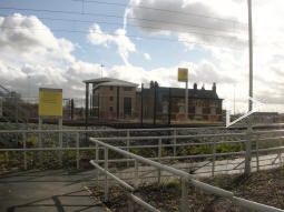 Auto-stitched panorama showing the Metrolink flag sign and the platforms from the Tweedale Way entrance