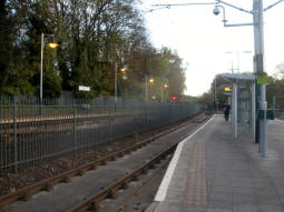 Railway and tram platforms from by the platform for trams to Nottingham