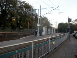 The island platform for trams with the side for trams to Hucknall nearest, with the railway platform behind