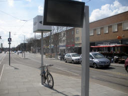 Tram and bus departures display and NET logo sign at the end of the platform