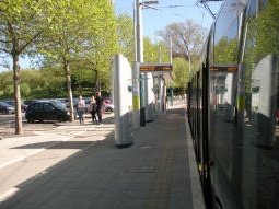 Looking along the platform for trams to Station Street with a tram at the platform