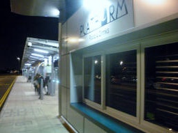 The food and drink kiosk closed at night, with the bus stops further in the background by platform A