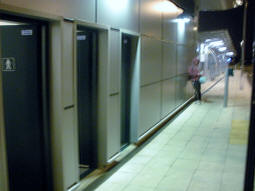 The toilets (just a toilet and sink per gender) at night with platform B in the background